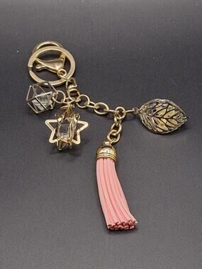 Gold Tone Charm Keychain with Pink Tassel – Geometric Cube, Star & Wire Sphere
